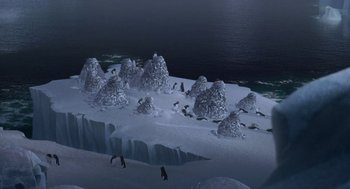 Movie still from “Surf's Up” (2007), directed by Chris Buck – A group of penguins standing on top of a snow covered slope; Extreme Wide shot, High angle