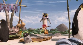 Movie still from “Surf's Up” (2007), directed by Chris Buck – An animated scene of a penguin and a bird in the sand; Wide shot, Low angle