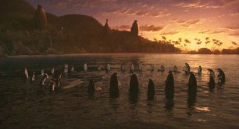 Movie still from “Surf's Up” (2007), directed by Chris Buck – A group of people in the ocean at sunset; Extreme Wide shot, High angle