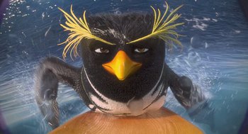 Movie still from “Surf's Up” (2007), directed by Chris Buck – A black and white bird with yellow feathers on its head; Extreme Close Up shot, High angle