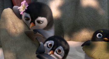 Movie still from “Surf's Up” (2007), directed by Chris Buck – A couple of penguins that are laying on the ground; Close Up shot, High angle