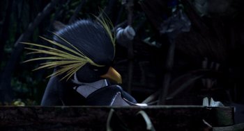 Movie still from “Surf's Up” (2007), directed by Chris Buck – A black bird with a yellow beak is sitting on a tree branch; Close Up shot, High angle