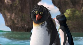 Movie still from “Surf's Up” (2007), directed by Chris Buck – A penguin that is standing in the water; Close Up shot, Over the shoulder angle