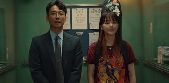 Movie still from “Sweet Home” (2020), directed by Eung Bok Lee – A man and a woman standing next to each other; Medium shot, Over the shoulder angle