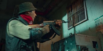 Movie still from “Sweet Home” (2020), directed by Eung Bok Lee – A man holding an ak - 4 7 in his hand; Medium shot, Low angle