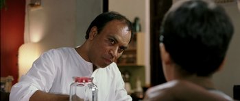 Movie still from “Like Stars on Earth” (2007), directed by Aamir Khan – A man sitting in front of a mirror looking at the camera; Close Up shot, Over the shoulder angle