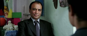 Movie still from “Like Stars on Earth” (2007), directed by Aamir Khan – A person wearing a suit and tie; Close Up shot, Low angle