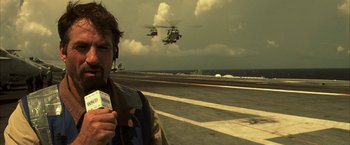 Movie still from “Tears of the Sun” (2003), directed by Antoine Fuqua – A man standing on top of an aircraft carrier; Close Up shot, High angle