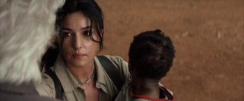 Movie still from “Tears of the Sun” (2003), directed by Antoine Fuqua – A woman standing next to a young child; Close Up shot, Over the shoulder angle