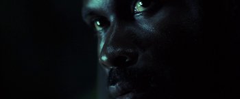 Movie still from “Tears of the Sun” (2003), directed by Antoine Fuqua – A man's face in the dark; Extreme Close Up shot, Low angle
