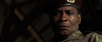 Movie still from “Tears of the Sun” (2003), directed by Antoine Fuqua – A person wearing a uniform; Close Up shot, Low angle