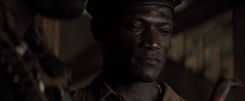 Movie still from “Tears of the Sun” (2003), directed by Antoine Fuqua – A person wearing a hat; Close Up shot, High angle