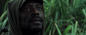 Movie still from “Tears of the Sun” (2003), directed by Antoine Fuqua – A person looking up at the sky; Close Up shot, Low angle