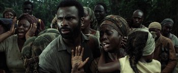 Movie still from “Tears of the Sun” (2003), directed by Antoine Fuqua – A group of people standing next to each other in a forest; Close Up shot, High angle
