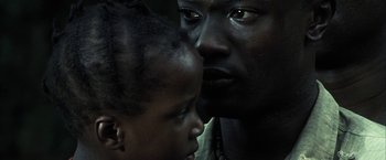 Movie still from “Tears of the Sun” (2003), directed by Antoine Fuqua – A man and a woman looking into each other's eyes; Extreme Close Up shot, Low angle