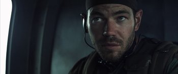 Movie still from “Tears of the Sun” (2003), directed by Antoine Fuqua – A person wearing headphones; Close Up shot, Low angle