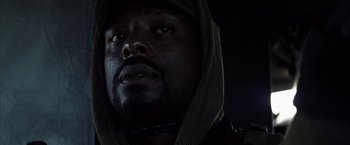 Movie still from “Tears of the Sun” (2003), directed by Antoine Fuqua – A person wearing a hooded jacket; Close Up shot, Low angle