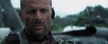 Movie still from “Tears of the Sun” (2003), directed by Antoine Fuqua – A person wearing a headset; Close Up shot, Low angle