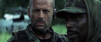 Movie still from “Tears of the Sun” (2003), directed by Antoine Fuqua – A person wearing a headset; Close Up shot, Over the shoulder angle