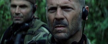 Movie still from “Tears of the Sun” (2003), directed by Antoine Fuqua – A person with a head wound; Close Up shot, Over the shoulder angle