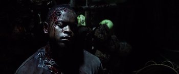 Movie still from “Tears of the Sun” (2003), directed by Antoine Fuqua – A man with blood all over his face and head; Close Up shot, High angle