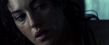 Movie still from “Tears of the Sun” (2003), directed by Antoine Fuqua – A woman's face in the dark; Close Up shot, Low angle
