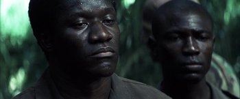 Movie still from “Tears of the Sun” (2003), directed by Antoine Fuqua – A man's face in the dark; Close Up shot, Low angle