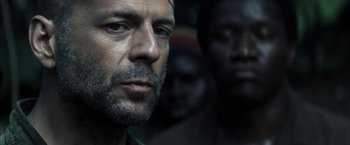 Movie still from “Tears of the Sun” (2003), directed by Antoine Fuqua – A person with a beard; Close Up shot, Over the shoulder angle