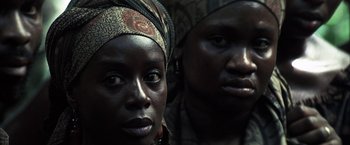 Movie still from “Tears of the Sun” (2003), directed by Antoine Fuqua – Two women with headscarves are looking at the camera; Close Up shot, High angle