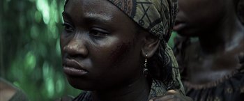 Movie still from “Tears of the Sun” (2003), directed by Antoine Fuqua – A person wearing a head scarf; Close Up shot, Over the shoulder angle
