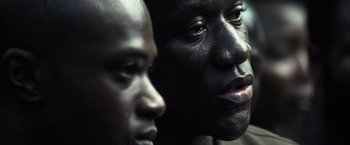 Movie still from “Tears of the Sun” (2003), directed by Antoine Fuqua – Two men are looking into the same direction; Close Up shot, Over the shoulder angle