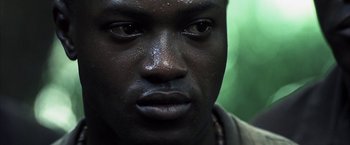 Movie still from “Tears of the Sun” (2003), directed by Antoine Fuqua – A man's face with water droplets on his face; Close Up shot, Low angle