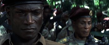 Movie still from “Tears of the Sun” (2003), directed by Antoine Fuqua – A person wearing a uniform; Close Up shot, Over the shoulder angle