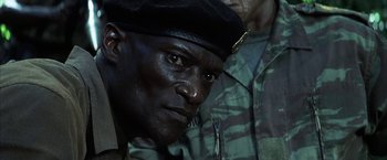 Movie still from “Tears of the Sun” (2003), directed by Antoine Fuqua – A person wearing a hat; Close Up shot, Low angle