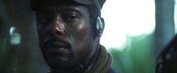 Movie still from “Tears of the Sun” (2003), directed by Antoine Fuqua – A person wearing headphones; Close Up shot, Low angle