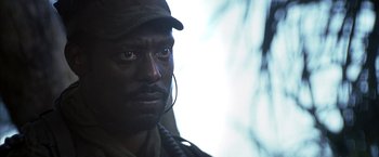 Movie still from “Tears of the Sun” (2003), directed by Antoine Fuqua – A person wearing a hat; Close Up shot, Low angle