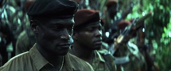Movie still from “Tears of the Sun” (2003), directed by Antoine Fuqua – Two men in military uniforms; Close Up shot, Low angle