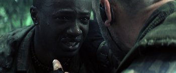 Movie still from “Tears of the Sun” (2003), directed by Antoine Fuqua – A man is looking at another man's face; Close Up shot, Over the shoulder angle