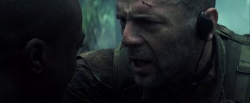 Movie still from “Tears of the Sun” (2003), directed by Antoine Fuqua – A person with a knife in his mouth; Close Up shot, Over the shoulder angle