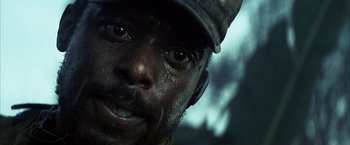 Movie still from “Tears of the Sun” (2003), directed by Antoine Fuqua – A man's face in the rain; Close Up shot, Low angle