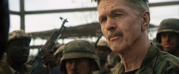 Movie still from “Tears of the Sun” (2003), directed by Antoine Fuqua – A person wearing a helmet; Close Up shot, Over the shoulder angle