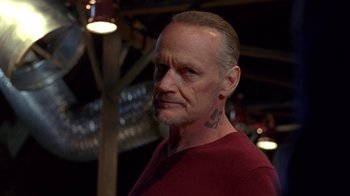 Movie still from “Breaking Bad” (2008), created by Vince Gilligan – A person wearing a red shirt; Close Up shot, Low angle