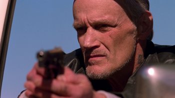 Movie still from “Breaking Bad” (2008), created by Vince Gilligan – An older man looking at a cell phone; Close Up shot, Low angle