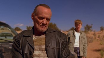 Movie still from “Breaking Bad” (2008), created by Vince Gilligan – A man in a leather jacket standing next to another man; Close Up shot, Low angle