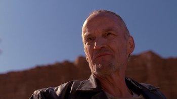 Movie still from “Breaking Bad” (2008), created by Vince Gilligan – An older man wearing a leather jacket looking at the camera; Close Up shot, Low angle