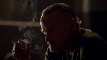 Movie still from “Breaking Bad” (2008), created by Vince Gilligan – A person smoking a cigarette; Close Up shot, Low angle