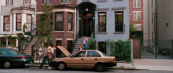 Movie still from “The Bounty Hunter” (2010), directed by Andy Tennant – A man standing next to an open car hood; Extreme Wide shot, High angle