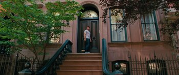Movie still from “The Bounty Hunter” (2010), directed by Andy Tennant – A man standing on the steps leading to a house; Wide shot, Low angle