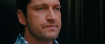 Movie still from “The Bounty Hunter” (2010), directed by Andy Tennant – A man's face with green eyes; Close Up shot, Over the shoulder angle