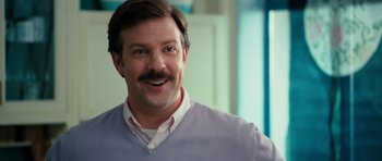 Movie still from “The Bounty Hunter” (2010), directed by Andy Tennant – A person with a mustache; Close Up shot, Over the shoulder angle